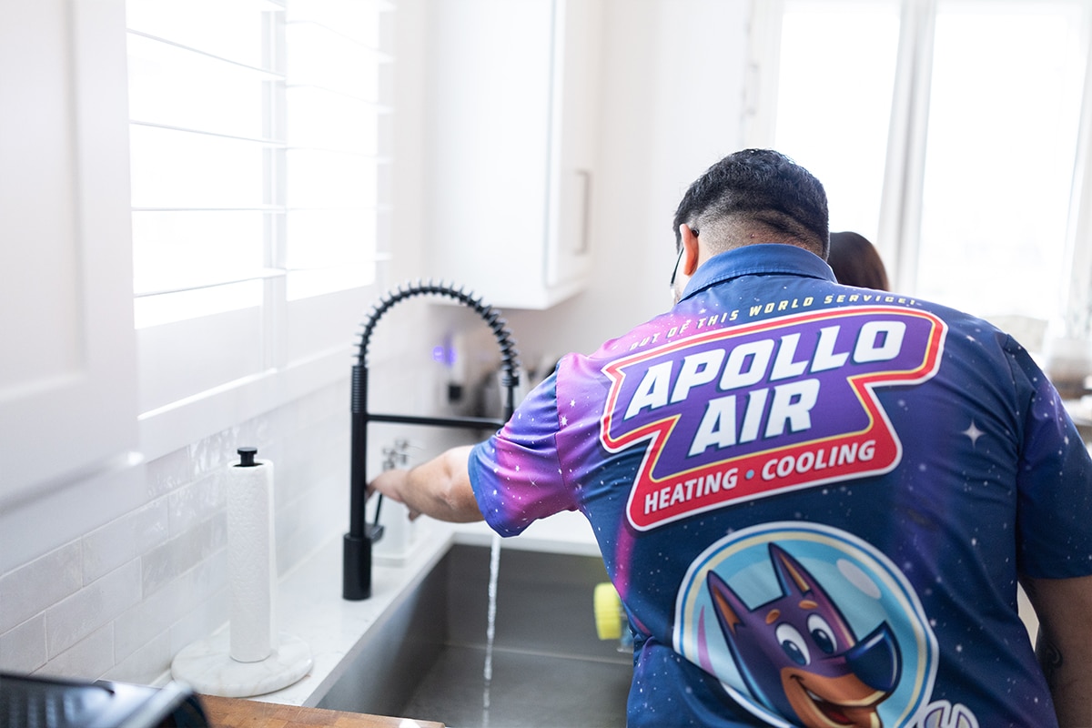 Apollo Air technician turning off faucet