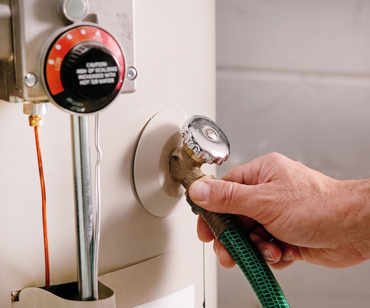 attaching hose to Rheem water heater drain valve for flushing